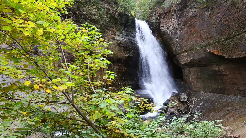Miners Falls in Autumn - Upper Peninsula of Michigan - Pictured Rocks. Miners Falls is a popular tourist attraction. Flowing fast, surrounded by autumn color before it spills into Lake Superior