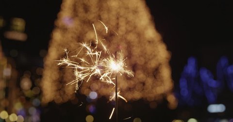 4K Cinemagraph: Close-Up Of Sparkler Glittering In Front Of Christmas Tree