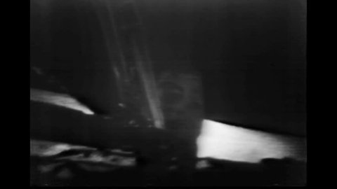 CIRCA 1960s - Enhanced footage of Apollo 11 astronauts walking on the moon.