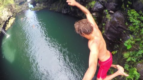 POV Slow Motion Cliff Jumping.  Lush Green Jungle in Hawaii. Extreme Sports GOPRO Selfie