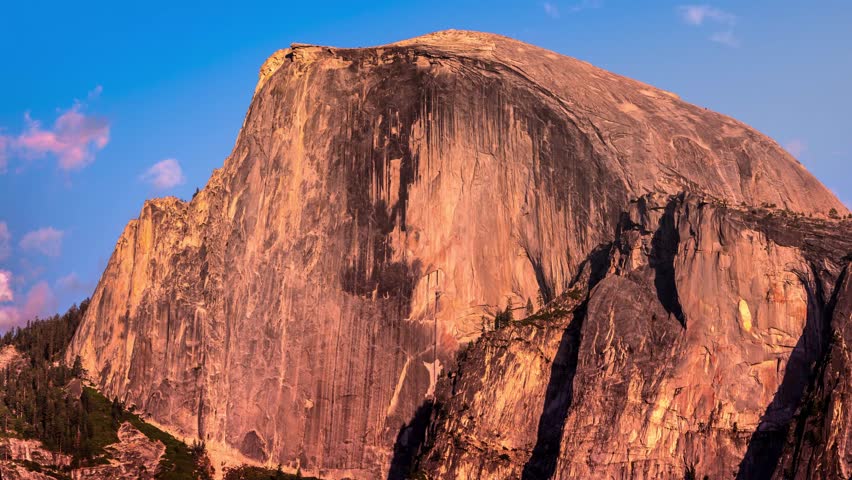 Half Dome sunset time lapse with clouds.  Yosemite National Park, California USA.