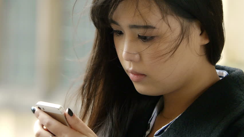 cute asian woman using smartphone to send messages