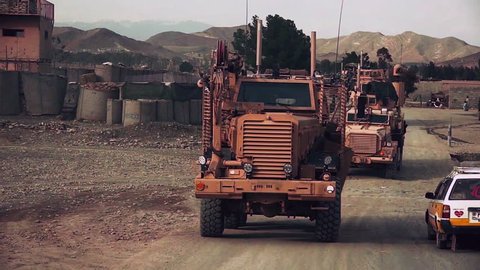 CIRCA 2010s - IED bomb sensing and disposal vehicles move along roads in Afghanistan.