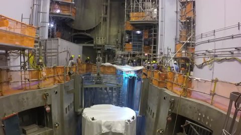 CIRCA 2010s - The core reactor of a nuclear power plant is put into place and fuel rod cells are added.