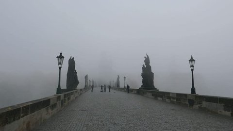 PRAGUE, CZECH REPUBLIC -NOV 3, 2015: Morning mist at Charles Bridge in Prague (Praha), Czech republic. It's a famous medieval bridge that crosses the Vltava river.