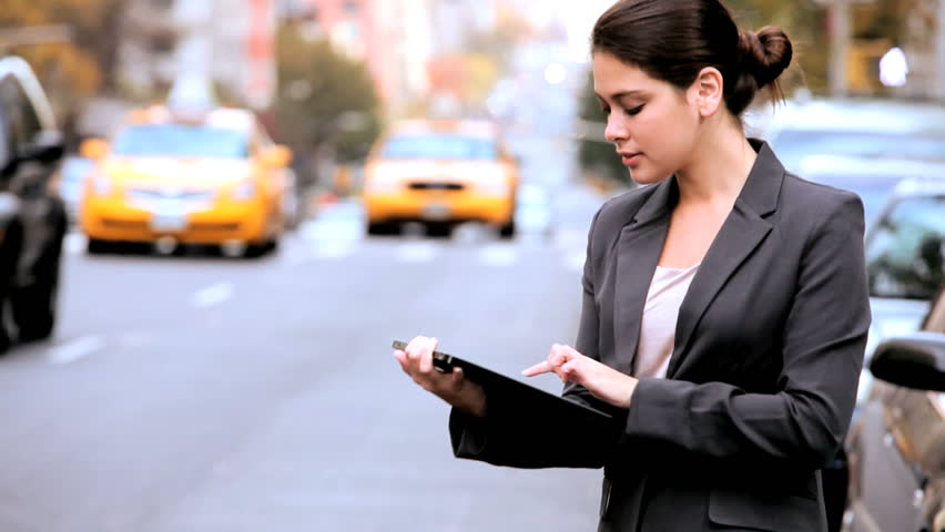 Young businesswoman in city clothes on the streets of New York working with a modern wireless tablet | Shutterstock HD Video #1334683