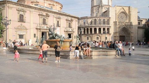 VALENCIA - JUNE 11: People enjoy a sunny Saturday afternoon at the historic Plaza de la Virgen square on June 11, 2011 in Valencia, Spain. Wide-angle shot (720p).