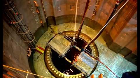 CIRCA 2010s - The core reactor of a nuclear power plant is put into place and fuel rod cells are added.