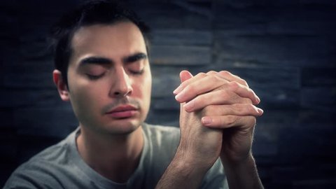 Young christian adult in praying position.