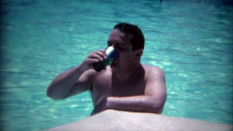 LAS VEGAS 1965: Man caught drinking in the pool by sexy legged cocktail waitress.