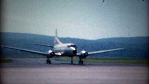 NEW YORK 1965: Convair CV-540 Allegheny Airlines propeller airplane taxis across airport.