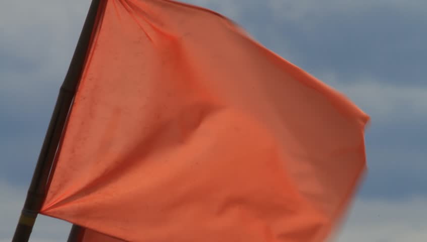 Red flag waving in the wind