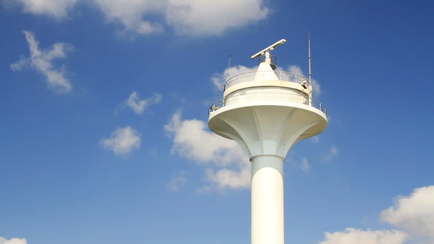 Vessel traffic radar navigation tower on a clear blue sky 