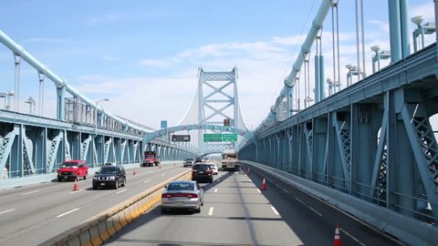 PHILADELPHIA, USA - SEPTEMBER 04, 2014: Cars moves at Benjamin Franklin Bridge at sunny day. Bridge is a suspension bridge across the Delaware River connecting Philadelphia and Camden