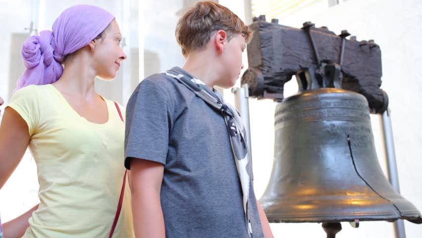 Mother with two children standing at the Liberty Bell. Philadelphia, USA