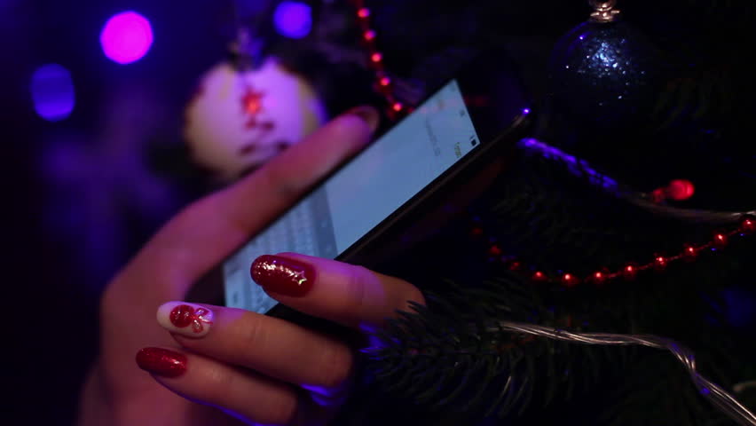 Young Woman Writing Sms In Front Of Christmas Tree 4