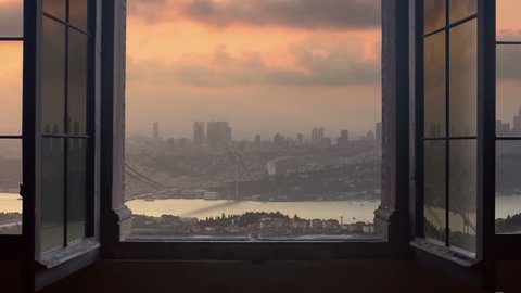 Timelapse of istanbul city skyline cityscape starting at the sunset ending at night as seen from a window camera moving out the house