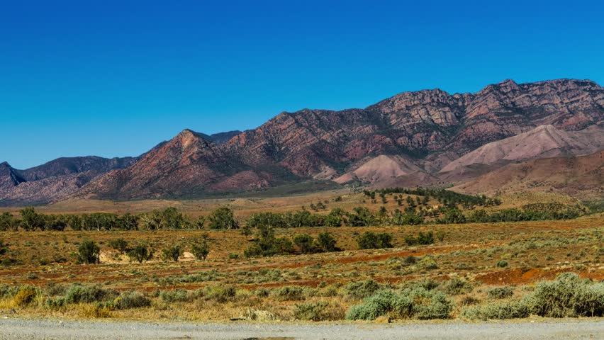 Cloudy desert landscape panorama with mountain ranges in background