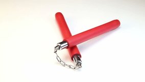 Crossed nunchuck with chain, video on white background