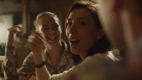 Friends laugh, drink beer and cocktails while having a good time together at a bar. Shot on RED Cinema Camera in 4K (UHD). - Βίντεο στοκ