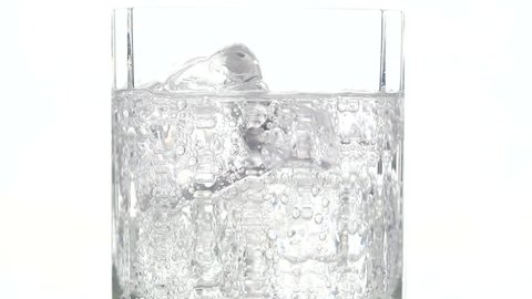 Close up of Drink Glass with Bubbling water and ice cubes