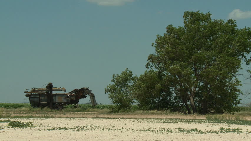 An abandoned antique agriculture machine on the dusty windswept plains of the Oklahoma panhandle. This rusty remnant is a reminder of the Dust Bowl of the 1930s.
