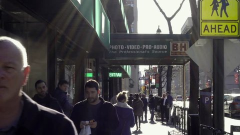 NEW YORK - NOV 29, 2015: People walking outside BH Photo Superstore, exterior shot on 9th Ave in 4K NY. B&H is a famous electronics store on 9th Avenue in Manhattan New York City.