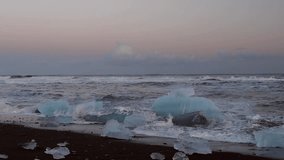 Woman tourist visiting famous beach in Vatnajokull Jokulsarlon, enjoying looking at the North Atlantic Ocean with icebergs, travel to Iceland. Full HD Video 1920x1080