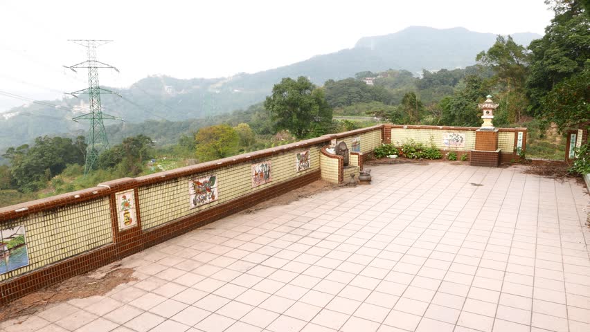 Old, empty and abandoned restaurant terrace on tea mountain slope. POV camera move forward emptiness and show panoramic view from terrace on tea plants over Maokong mountainside area
