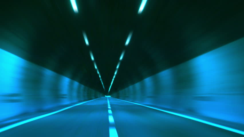 Driving through tunnel, abstract with motion blur and glow. 