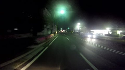 Helmet view. Riders running in the street at night.