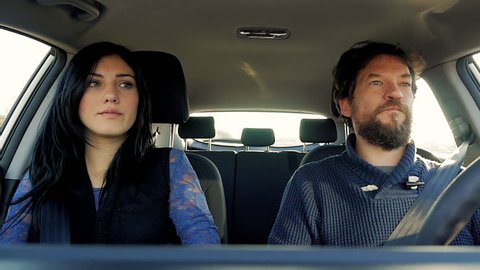 Couple in car angry fighting unhappy driving slow motion