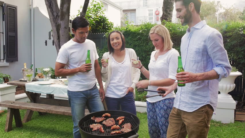 Diverse group of friends cooking meat on fire and drinking beers having fun together at garden party lifestyle weekend Royalty-Free Stock Footage #13428941