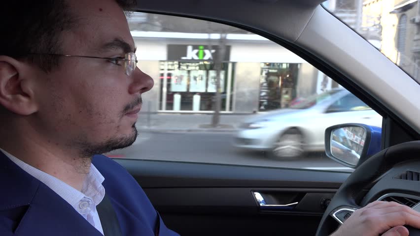 Driving to work during the day by car, focused attentive driver in traffic 4K | Shutterstock HD Video #13430612