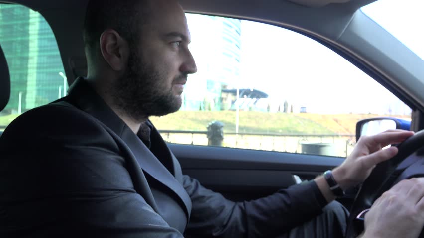Anxious businessman in a hurry waiting heavy traffic, inside car, steering wheel | Shutterstock HD Video #13430744