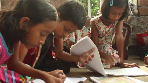 Girl students sketch and draw at a school for underprivileged kids in Bengal, India.
