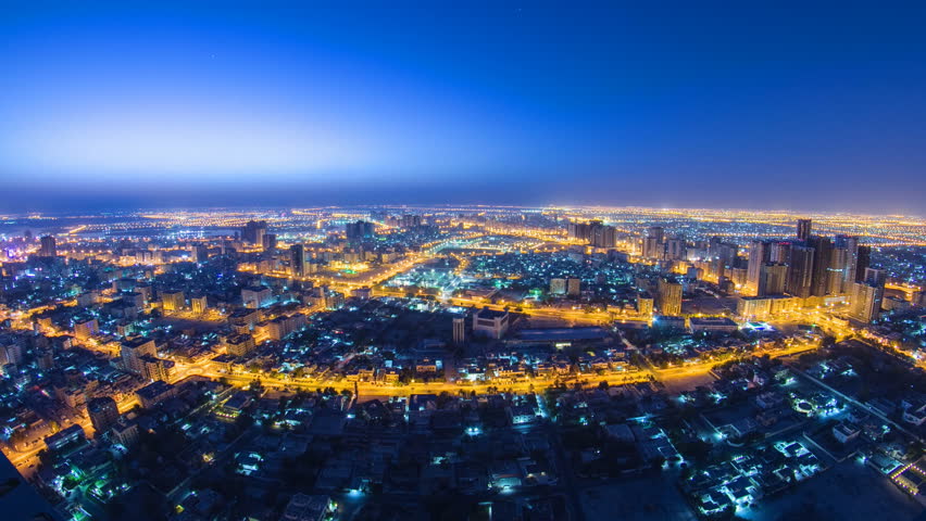 Cityscape of Ajman from rooftop from night to day transition timelapse. Ajman is the capital of the emirate of Ajman in the United Arab Emirates. fisheye 4K | Shutterstock HD Video #13439351