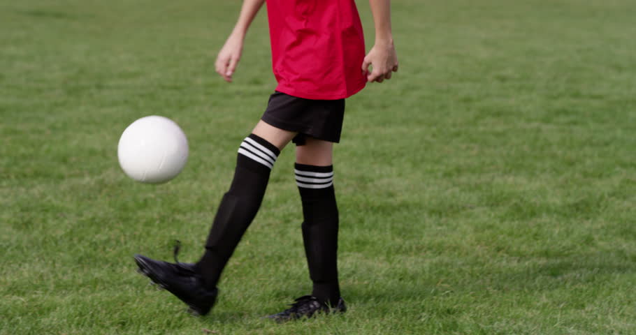 A young boy practices his soccer skills. Shot in slow motion on RED Epic. | Shutterstock HD Video #13443095
