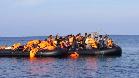 LESVOS, GREECE October 18, 2015: Refugees arriving in Greece in dinghy boat from Turkey. These Syrian, Afghanistan and African refugees land their boat at the North coast of Lesvos near Molyvos.
