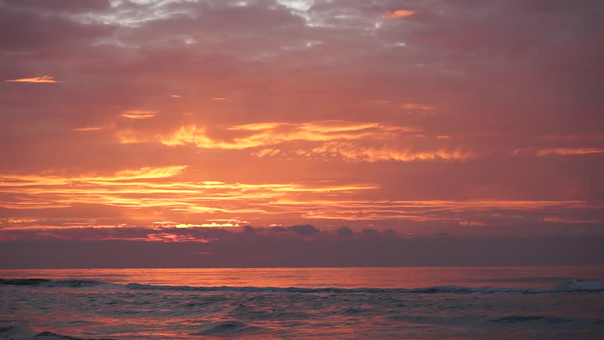 Sunset at the Adriatic Sea in Albania near Durres: straight after the descend of the sun. The sky is red and covered with pink clouds.