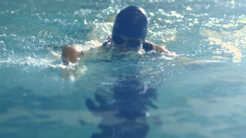 Shot from Front Side of Professional Female Swimmer Performing Front Crawl during Training in Swimming Pool. Shot on RED Cinema Camera in 4K (UHD).