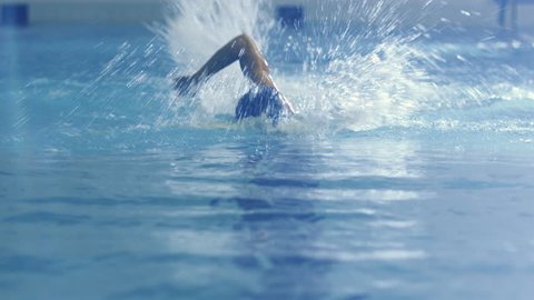 Shot from Front Side of Professional Female Swimmer Performing Front Crawl during Training in Swimming Pool. Shot on RED Cinema Camera in 4K (UHD).