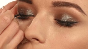 Eye makeup woman applying eyeshadow powder. Beautiful woman face. Perfect makeup. Beauty fashion. Eyelashes. Cosmetic Eyeshadow. close up