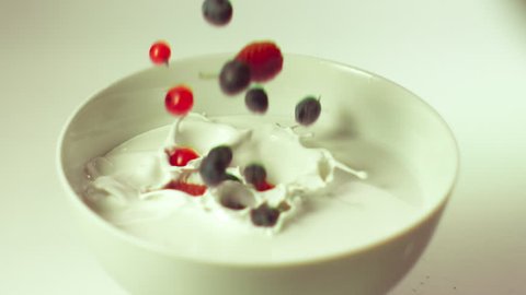 blueberry raspberry blackberry falls into the cream 