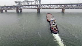 Aerial view of tug boat pushing empty barge