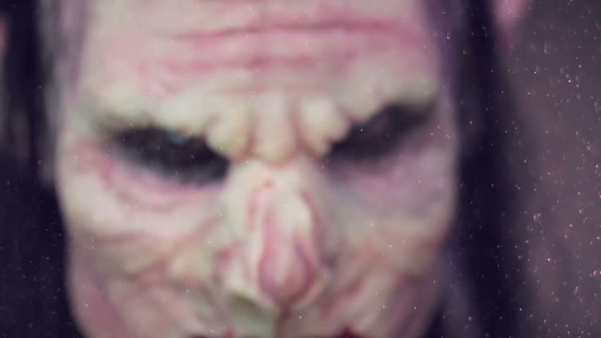 Closeup portrait of dreadful male vampire.