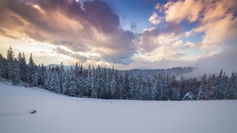 Time lapse clip. Colorful winter sunset in the Carpathian mountains, Ukraine, Europe. 4K video (Ultra High Definition).