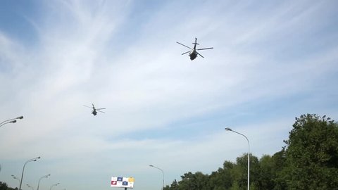 MOSCOW, RUSSIA - AUG 20, 2014: Two helicopters above Leningradskoye highway behind Moscow ring highway area.