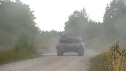 CIRCA 2010s - M 1 Abrams tank moves along a road.