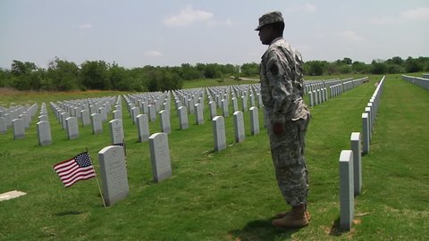 CIRCA 2010s - Soldiers honor the dead at a cemetery in Dallas Ft. Worth, Texas.